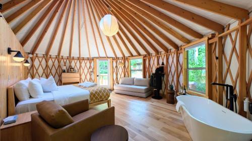 a room with a bed and a tub in a yurt at Desolation Hotel Hope Valley in Markleeville