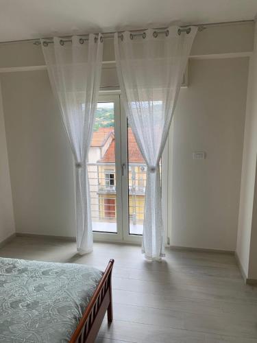 a bedroom with a bed and a large window at Da Mina Rooms & Apartament in Flumeri