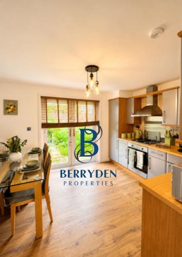 a kitchen with a table and a dining room at Restmore House in Inverugie Mill