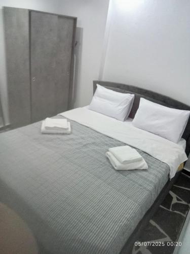 a bed with two towels sitting on top of it at MAGIA's HOUSE in Karistos