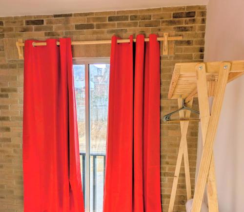 a red curtain in front of a window at Chepicche Inn in Oaxaca City
