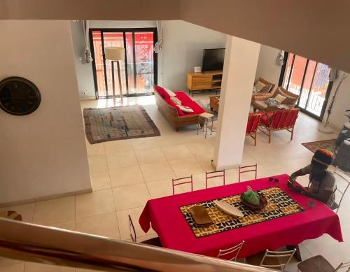 an overhead view of a living room with a red table at Paradise in Yène