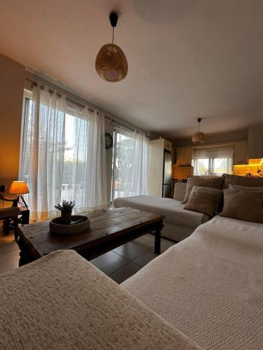a living room with a couch and a table at Lithos in Khalkoútsion