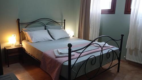 a bedroom with a bed with a metal frame at House with garden in Agria