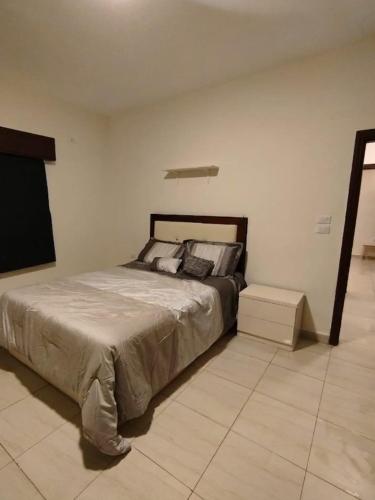 a bedroom with a large bed in a room at مزرعة لافين in Jerash
