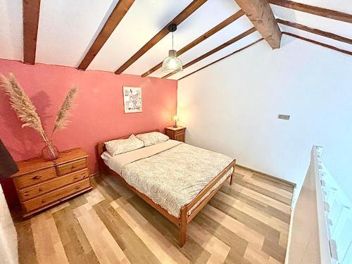 a bedroom with a bed and a wooden floor at Maison proche vallon pont d arc in Salavas