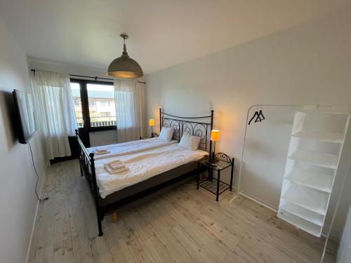 a bedroom with a bed with a black bed frame at Lysekil Apartment Hotel in Lysekil