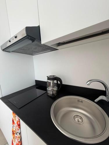 a kitchen counter with a sink in a kitchen at Al58 Casa Vacanze in Villasmundo