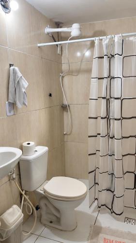 a bathroom with a toilet and a shower curtain at Casa a 8 minutos do Parque do Povo - Campina Grande PB in Campina Grande