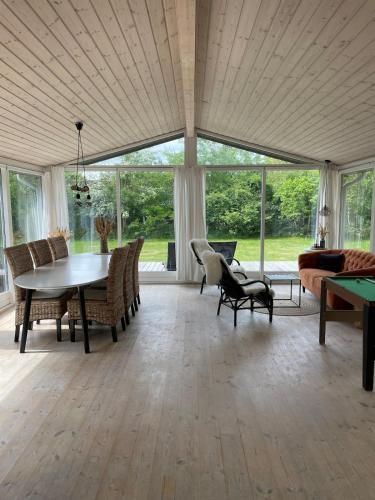 a large living room with a table and chairs at Charming House Close To The Beach in Gedser