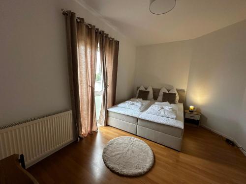 a bedroom with a bed and a large window at Lesum View Apartment Bremen in Bremen
