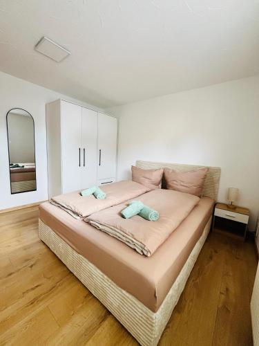 a bedroom with a large bed with two pillows on it at Ferienhäuser Radebeul "Maisonette Klein Nizza" in Radebeul