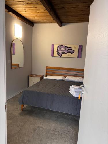 a bedroom with a bed and a wooden ceiling at Family in Envie