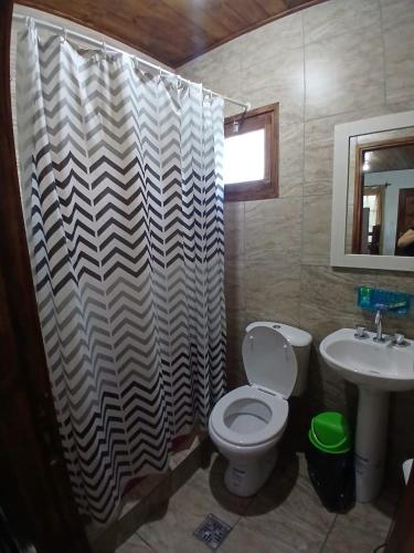 a bathroom with a toilet and a sink at Cabañas amanecer alegre in Salta