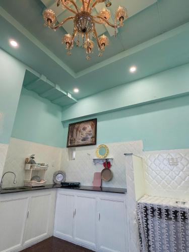 a kitchen with a ceiling with a chandelier at VV House and Cinema 2 in Quy Nhon