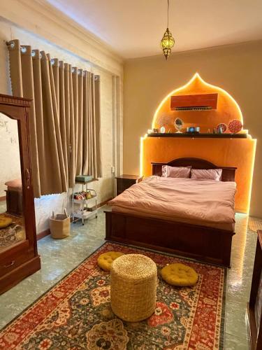 a bedroom with a large bed and a rug at VV House and Cinema 2 in Quy Nhon