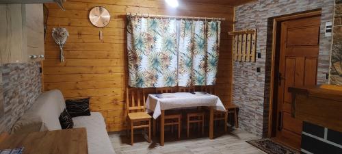 a wooden room with a table and a window at Domki Żaklin in Berezka