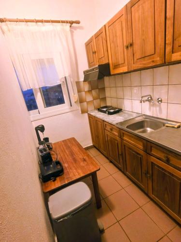 a small kitchen with a table and a sink at Pansion Panorama in Skala Marion