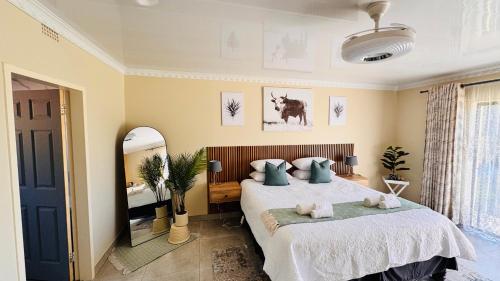 a bedroom with a bed with two stuffed animals on it at Jwalaboholo Mountain View Guest House in Ficksburg