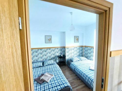 a room with two beds and a mirror at Apartament Janka in Zator