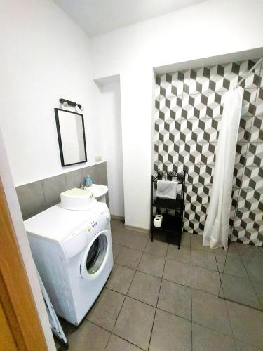 a washing machine in a bathroom with a mirror at Apartament Janka in Zator