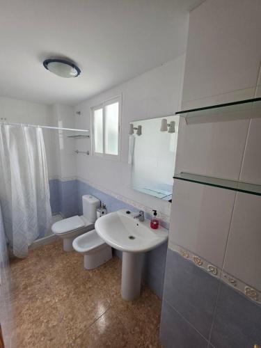 a bathroom with a white sink and a toilet at Durino apartment with terrace in Moncófar