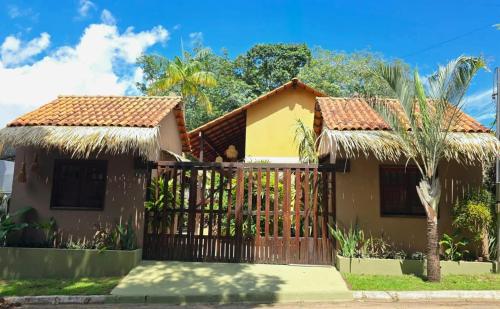 a house with a gate in front of it at Vila Rudá - Alter do Chão in Alter do Chao