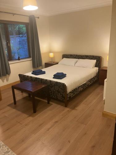a bedroom with a bed and a table and a window at Clifden townhouse in Clifden