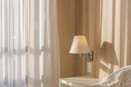 Ένα ή περισσότερα κρεβάτια σε δωμάτιο στο Aquarius Hotel Flat Residence
