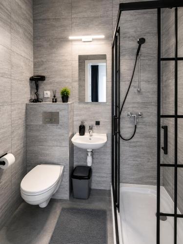 a bathroom with a toilet and a sink and a shower at Pokoje gościnne Moli in Łeba