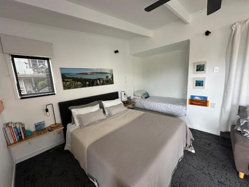 a bedroom with a large bed and a window at Beach view studio 337 in Omapere