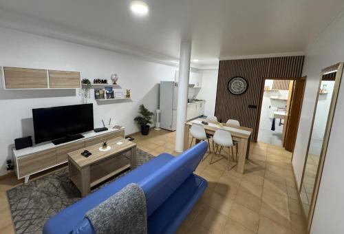 a living room with a blue couch and a table at Alforra Residence 1-T2-centro-praias-Levadas in Câmara de Lobos