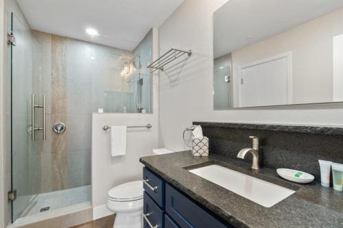 a bathroom with a sink and a shower and a toilet at Pine Acres 122 - Halfway to Heaven in Durango