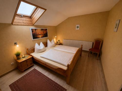 a bedroom with a large bed and a skylight at Ferienwohnung Bischofshäusl in Berchtesgaden