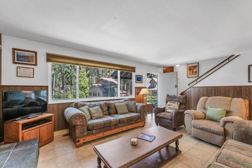 a living room with a couch and a tv at Foothill Folly home in Zephyr Cove
