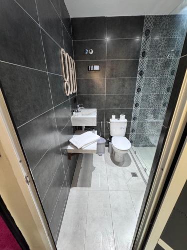 a bathroom with a toilet and a sink and a shower at Amor Hotel in Fez