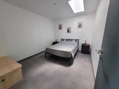 a bedroom with a bed in a white room at Les écuries in Secondigny