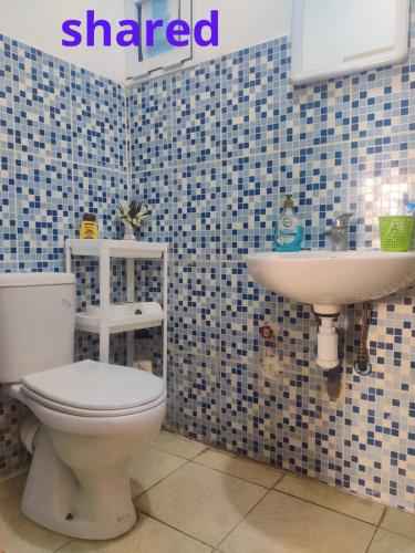a bathroom with a toilet and a sink at Room in Agadir with shared bathroom in Agadir