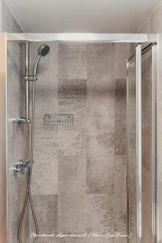 a shower with a glass door in a bathroom at The Priory House in Tynemouth