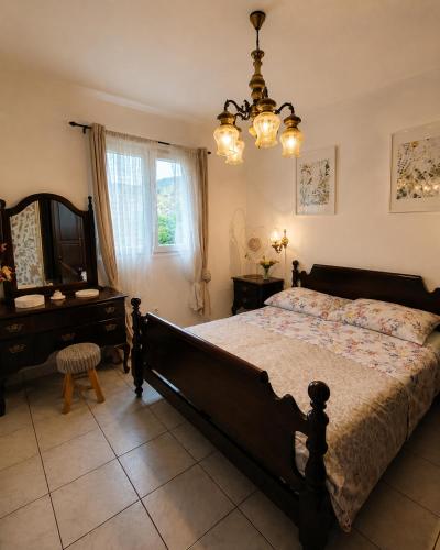 a bedroom with a bed and a desk and a window at Panoramic view with jacuzzi in Vis