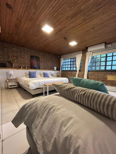 a large room with two beds and a couch at Casa Reconquista in Mendoza
