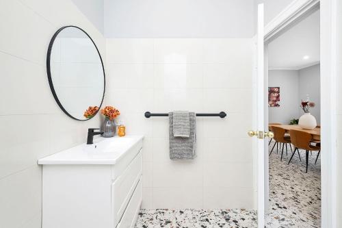 a white bathroom with a mirror and a sink at 496 Classic Character Home with Charm in Perth