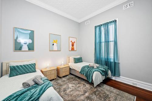 a bedroom with two beds and a window at 496 Classic Character Home with Charm in Perth
