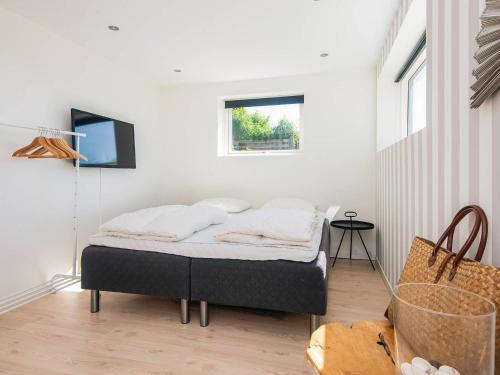 a bedroom with a bed in the corner of a room at 5 star holiday home in Kolding in Kolding