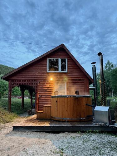 a small house with a hot tub in front of it at Chata Ignasia in Stronie Śląskie
