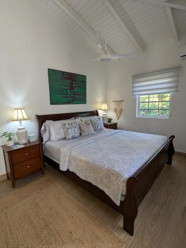 a bedroom with a large bed and a window at 2 Bedroom Dream Cottage-Point Blanche in Philipsburg