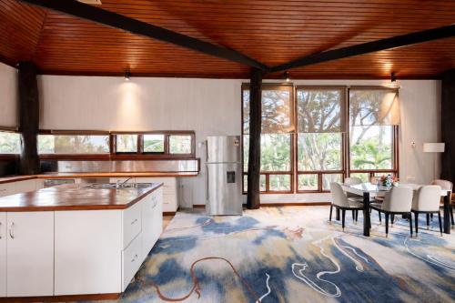 a kitchen and dining room with a table and chairs at Rainbow Holiday Resort in Nadi