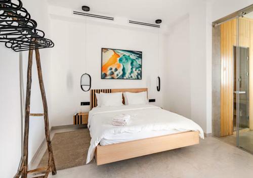 a bedroom with a large bed with white sheets at The Blue Mirage in Tangier