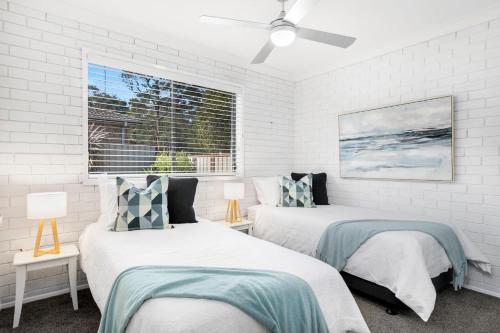 a bedroom with two beds and a window at Southcoast Haven in Shoalhaven Heads