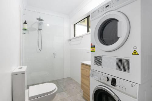 a washing machine in a bathroom with a toilet at Southcoast Haven in Shoalhaven Heads